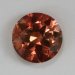 Moderately dichroic round with slices of different shades of pastel orange.  #989