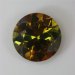 Lightly included, dichroic mixture of gold and slightly greenish yellow flash in a medium dark world.  #992