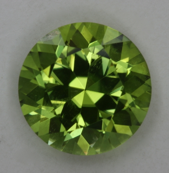 Exceptional yellow green copper bearing round.  #62