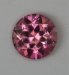 Slightly included pink to orange round.  #1022