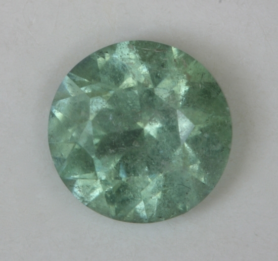 Moderately included minty green droplet of color.