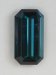 Dark toned, blue shifting toward green, closed ended emerald cut.