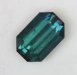 Nice emerald cut with a blue to blue green color.
