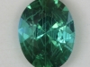 Oval with a good blue green color and a modern art like array of inclusions.  #240
