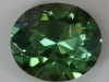 Dichroic green oval with faint feather under the table.  #249