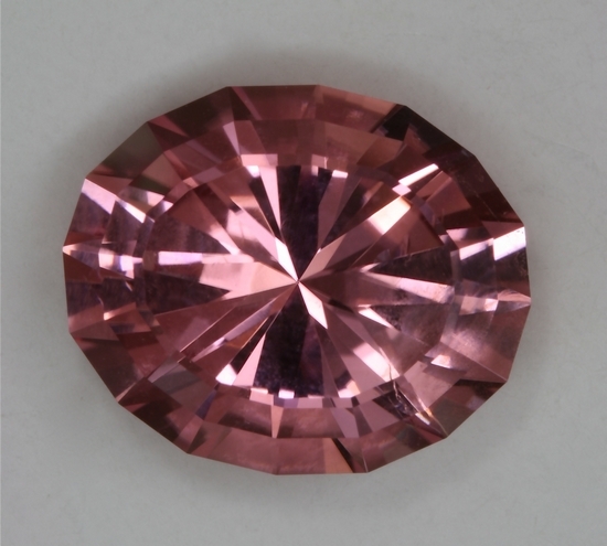 Slightly included, bright, medium light tone level, pink oval.  #254