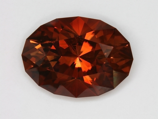A lighter medium tone level brown to orange brown dravite. oval  #298
