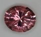 Slightly included, bright, medium light tone level, pink oval.  #254