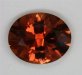 A medium tone dravite of brownish orange/golden color, oval  #258