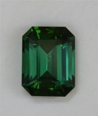 A saturated blue to green colored emerald cut that slides with the light.  #389
