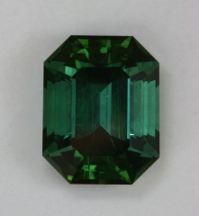 An excellent dichroic, medium toned green with touch of blue emerald cut.  #392