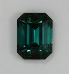 A medium dark toned blue green emerald that is included.  #394
