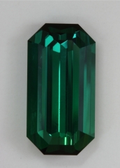 A fine classic dichroic blue green emerald cut with steep ends.  #400