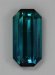 Flawed, medium dark toned, saturated blue emerald cut.  #391