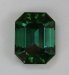An excellent dichroic, medium toned green with touch of blue emerald cut.  #392