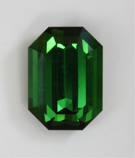 Pure crystal like clarity, closed ended, green emerald cut.  #418