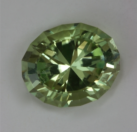 Very bright, slightly included, yellow with a wash of green, oval.  cuprian  #419