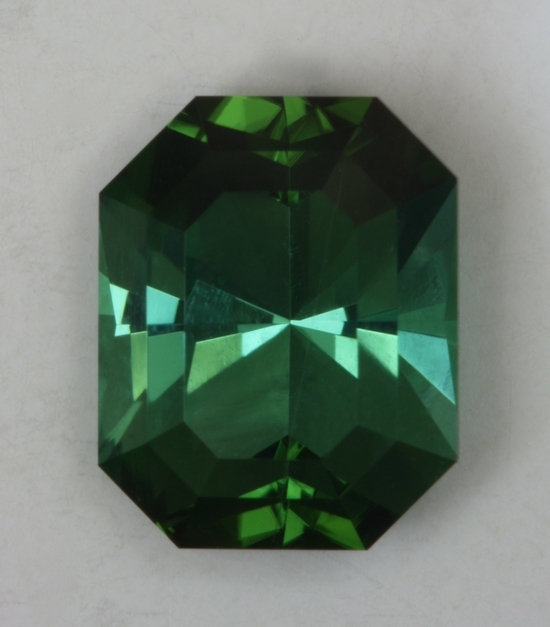 Moderately toned, bluish green hexagonal cut.  #422