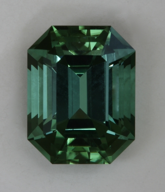 Barely dichroic, completely open, green with touch of blue, emerald cut.  #428