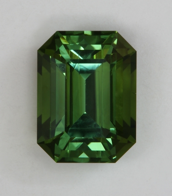 Barely dichroic bronze and green, medium toned, emerald cut.  #429