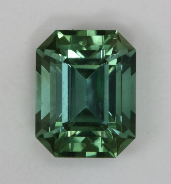 A completely open, slightly dichroic, pastel blue green emerald cut.  #439