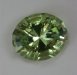 Very bright, slightly included, yellow with a wash of green, oval.  cuprian  #419