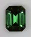 Medium toned green emerald cut with semi open ends.  #433