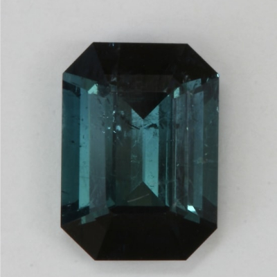 emerald cut dark blue flawed tourmaline gem