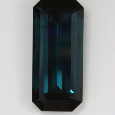 emerald cut blue flawed dark tourmaline gem